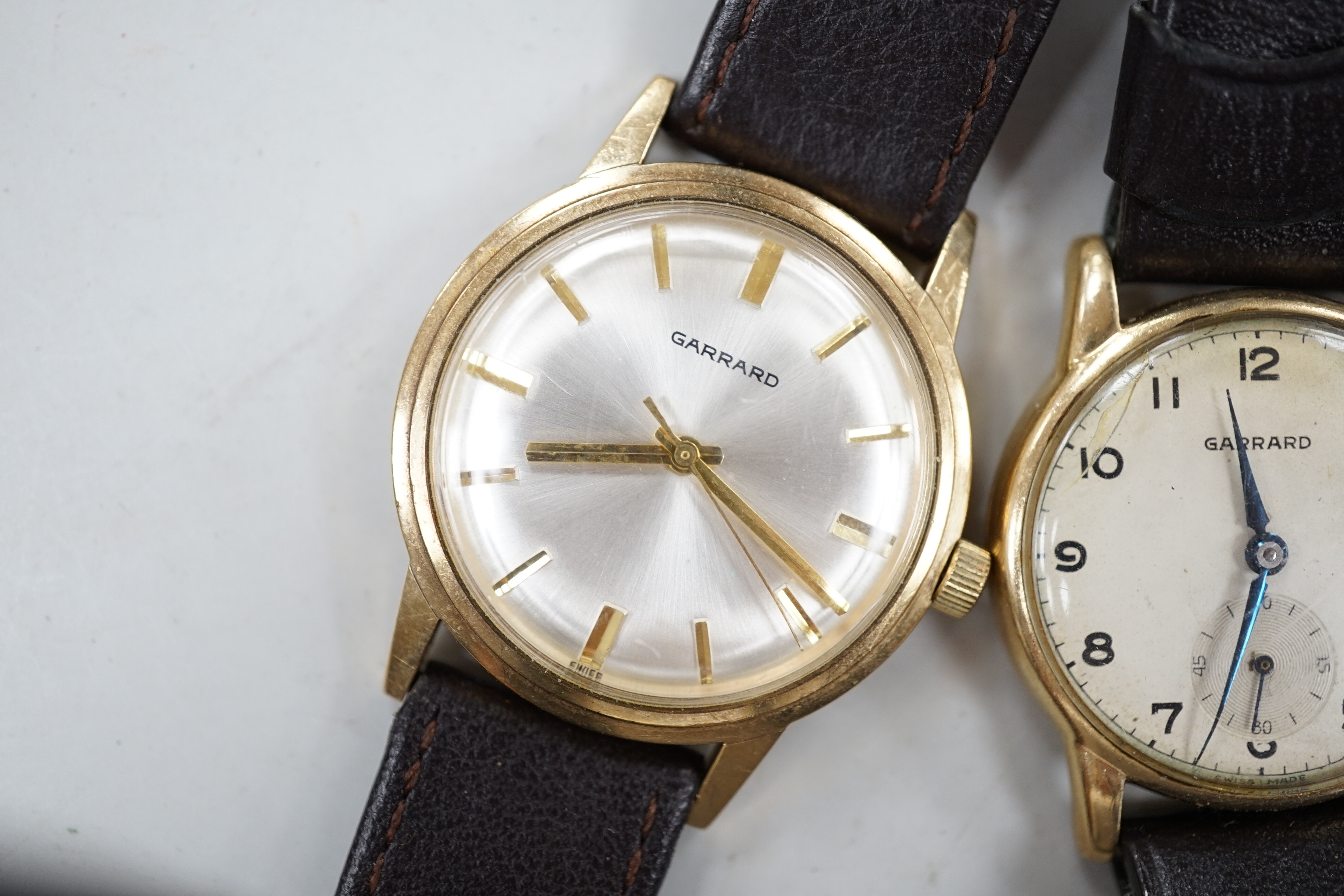 Two gentleman's 9ct gold manual wind wrist watches, retailed by Garrards, both with engraved inscription and two other 9ct gold wrist watches including Eterna.